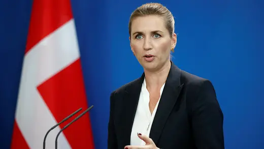 Denmark's Prime Minister Mette Frederiksen speaks on stage during a news conference.